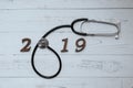 2019 Happy New Year for healthcare, Wellness and medical concept. Stethoscope with wooden number on table Royalty Free Stock Photo