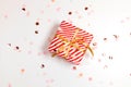 Happy New Year horizontal composition. Christmas striped design gifts box, golden bow, glitter light on white background with copy Royalty Free Stock Photo