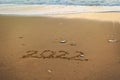 2022 Happy New Year inscription sand beach