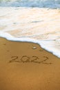 2022 Happy New Year inscription sand beach