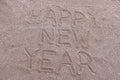 happy new year inscription on the sand.