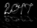 Happy new year 2017 isolated numbers with water reflection written smoke or fire on black background