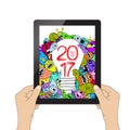 Happy new year 2017. Isolation man hand holding the tablet and Monster idea Royalty Free Stock Photo