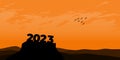 Happy New year 2023 with large silhouette letters on the mountain with a beautiful sunset for success concept. new year concept