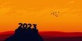 Happy New year 2023 with large silhouette letters on the mountain with a beautiful sunset for success concept. new year concept