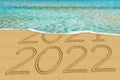 Happy New Year 2022 and leaving year of 2021 concept text on the sea beach