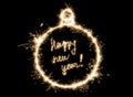 Happy New Year lettering with sparklers on black background in sparklers in the shape of a christmas ball Royalty Free Stock Photo