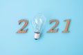 2021 Happy New year with lightbulb with and wooden number. New Start, Idea, Creative, Innovation, Resolution, Solution, Strategy,