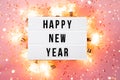 Happy New Year 2022 lletter board light box with christmas decorations and garland sparkling lights.CHristmas and Royalty Free Stock Photo