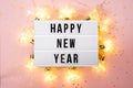 Happy New Year 2022 lletter board light box with christmas decorations and garland sparkling lights.CHristmas and Royalty Free Stock Photo