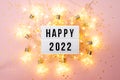 Happy New Year 2022 lletter board light box with christmas decorations and garland sparkling lights.CHristmas and Royalty Free Stock Photo