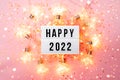 Happy New Year 2022 lletter board light box with christmas decorations and garland sparkling lights.CHristmas and Royalty Free Stock Photo