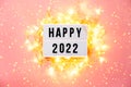 Happy New Year 2022 lletter board light box with christmas decorations and garland sparkling lights.CHristmas and Royalty Free Stock Photo