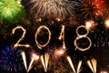 Happy new year 2018 written with sparkles and colorful fireworks as a background Royalty Free Stock Photo