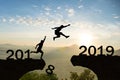 Happy New Year 2019 Men jump over silhouette mountains Royalty Free Stock Photo