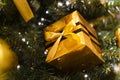 Happy New Year. Merry Christmas. Big beautiful shiny gold box surprise. Bokeh background yellow ribbon bow toy balloon. Gift Royalty Free Stock Photo