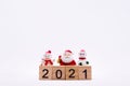 Happy New Year and Merry Christmas 2021 concept. Ceramic happy Santa Claus and Snow man doll standing behind wooden text 2021. Royalty Free Stock Photo