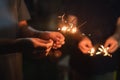 Happy new year and merry christmas group of people family with sparkler fire lighting concept, Hand holding a burning sparkler Royalty Free Stock Photo