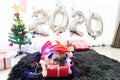 Happy New Year 2020, Merry Christmas, holidays and celebration, Puppy pets bored sleeping rest in the room with Christmas tree. Royalty Free Stock Photo