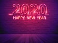 2020 happy new year with neon light alphabet on brick wall room background Royalty Free Stock Photo