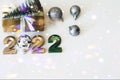 Happy New Year 2022. Number 2022 is executed in gold color on a light background with a block. Christmas background with craft Royalty Free Stock Photo