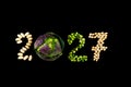 Happy New Year 2027- number made of beans, peas, grains on black wooden background