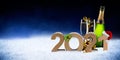 Happy new year 2021 number with santa hat four leaf clover champagne bottle glass snow front of blue black bokeh night panorama Royalty Free Stock Photo