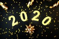 2020 Happy New Year. Number 2020 written on black background. Glowing overlay template for holiday greeting card Royalty Free Stock Photo