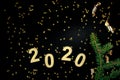 2020 Happy New Year. Number 2020 written on black background. Glowing overlay template for holiday greeting card Royalty Free Stock Photo