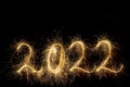 Happy New Year 2022. Number 2022 written sparkling sparklers isolated on black background with copy space for text. Royalty Free Stock Photo