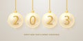 Happy New Year 2023. Numbers hang on a ribbon in transparent glass Christmas balls.