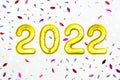 2022 Happy New Year numbers text, colorful confetti on white background. Christmas party greeting decor Royalty Free Stock Photo