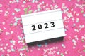 happy new year 2023 party celebration flat lay with confetti in pink