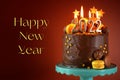 Happy New Year&#x27;s Eve 2022 Chocolate Cake Decorated With Gold Burning Candles