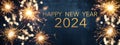 HAPPY NEW YEAR 2024 / New Year`s Eve Party background greeting card  - Sparklers and bokeh lights, on dark blue night sky Royalty Free Stock Photo