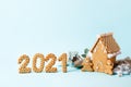 Happy New Year`s set of numbers 2021, gingerbread man in face mask from ginger biscuits glazed sugar icing decoration on blue bac Royalty Free Stock Photo