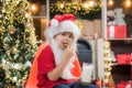 Happy new year. Santa Claus eating cookies and drinking milk on Christmas Eve. Portrait of little Santa child holding