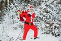 Happy new year. Santa Claus pulling huge bag of gifts on white nature background. Santa in the winter field. Merry Royalty Free Stock Photo