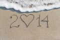 Happy New Year 2014 on the sea sandy beach with heart Royalty Free Stock Photo