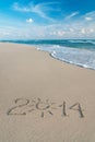 Happy New Year 2014 season concept on sea beach with the sun ray Royalty Free Stock Photo