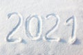 Happy new year 2021 sign text written with numbers from snow on snow surface, symbol of the next year marked against a Royalty Free Stock Photo