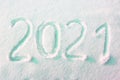 Happy new year 2021 sign text written with numbers from snow on snow surface, symbol of the next year marked against a Royalty Free Stock Photo