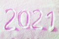 Happy new year 2021 sign text written with numbers from snow on snow surface, symbol of the next year marked against a Royalty Free Stock Photo