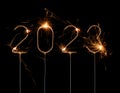 Happy New Year 2023 Silvester party card. Digits of year 2023 made by golden burning sparklers isolated on black Royalty Free Stock Photo