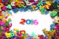 Happy new year 2016 from sparkles colorful glitters numbers on white background and around other numbers Royalty Free Stock Photo