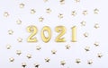 Happy New Year 2021. Sparkling Gold Numbers On White Background With Stars. Object For Design Holiday Greeting Card,