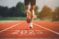 Happy new year 2023 Sport man runner running into the new year 2023. Start up of close up foot shoes jogging at stadium go to Goal Royalty Free Stock Photo