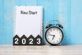 2023 Happy New Year with New start, black retro alarm clock and wooden number.Resolution, Goals, Plan, Action and Mission Concept Royalty Free Stock Photo