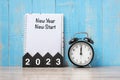2023 Happy New Year with New Year New start, black retro alarm clock and wooden number.Resolution, Goals, Plan, Action and Mission Royalty Free Stock Photo