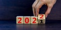 2022 happy new year symbol. Businessman turns a cube, symbolize the change from 2021 to the new year 2022. Beautiful black Royalty Free Stock Photo